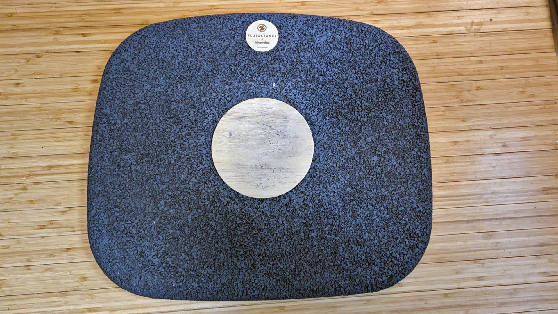 An anti-fatigue mat with a wood center
