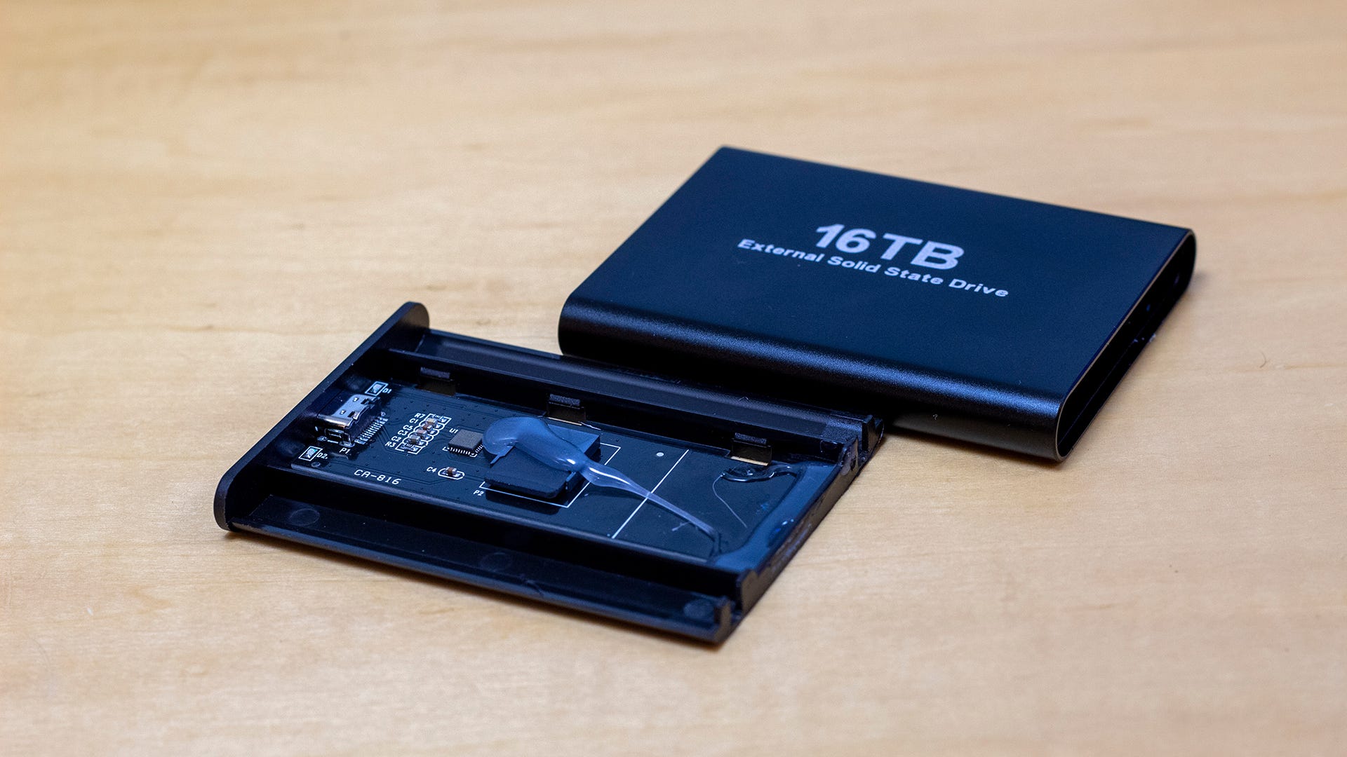 A torn apart hard drive revealing a micro SD card inside