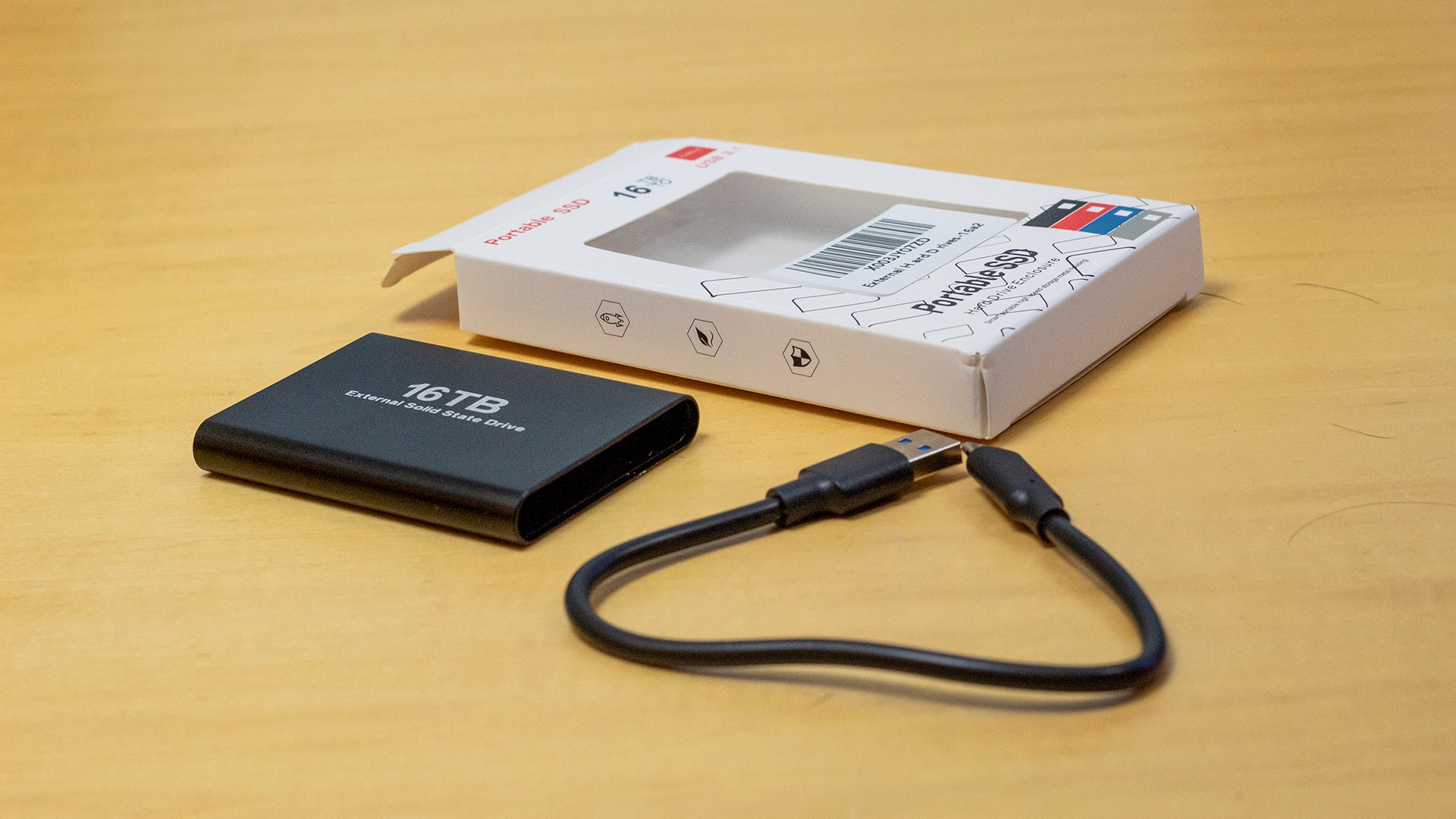 A fake SSD drive next to a box and a USB-C cord