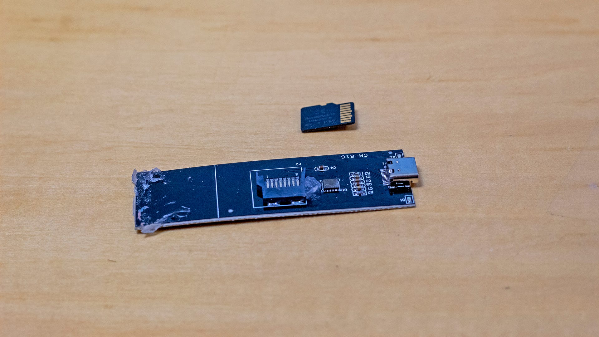 A microSD card next to a USB-C board