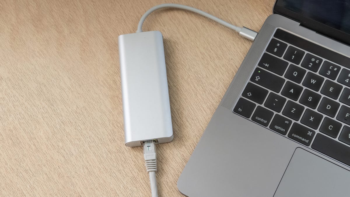 USB-C to Ethernet adapter attached to a MacBook Pro.