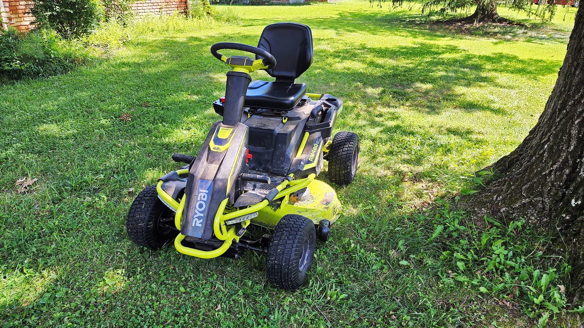 A green battery-powered riding lawnmower 