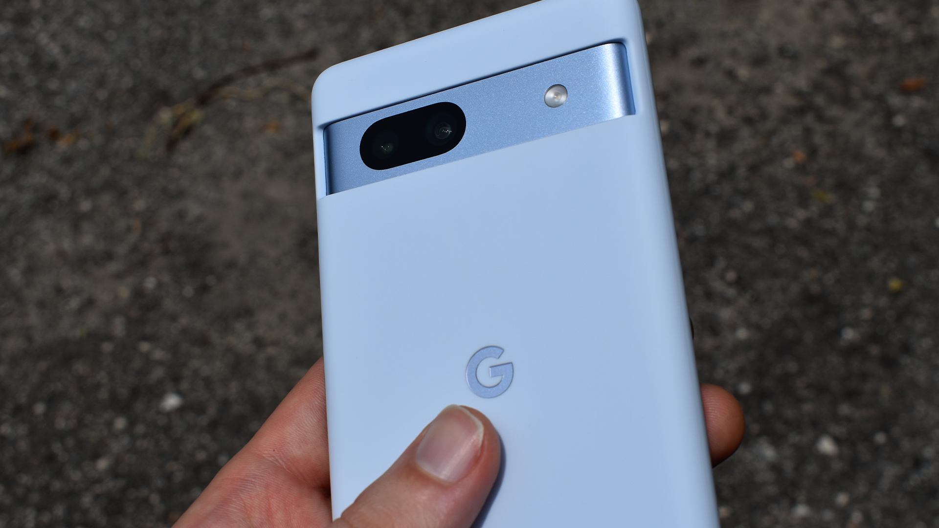 The Google Pixel 7a in a blue Google-made phone case.